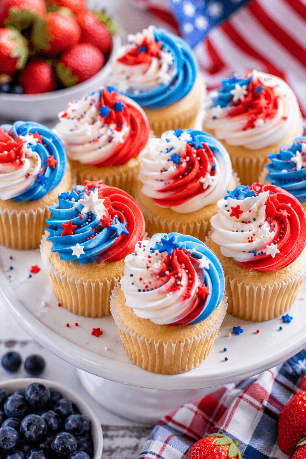 Vanilla cupcakes with red, white, and blue buttercream swirls